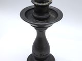 a black candle holder on a white background