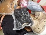 un tas de vêtements et de sacs par terre