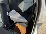 a seat in the back of a car with a book in it