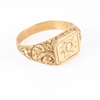 a close up of a gold signet ring on a white background