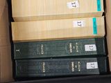 many books in a box that are stacked on top of each other