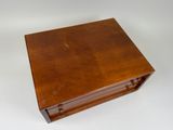 an old wooden box sitting on top of a white surface