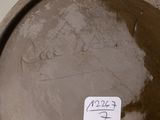 a close up of a brown vase with a sticker on it