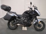 a picture of a black and white motorcycle parked in a garage