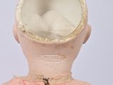 a doll with a pink dress and a hat on it