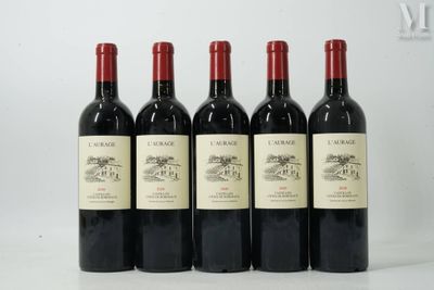 six bottles of red wine are lined up on a table