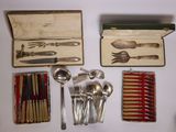 many different types of silverware in a box on a table