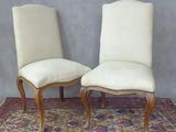 une paire de chaises de salle à manger rembourrées posées sur un tapis