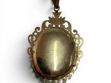 an image of a gold locke with a cat ' s eye in it