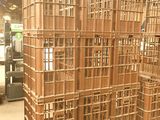 many wooden crates stacked on pallets in a warehouse