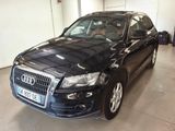 an image of a black audi suv parked in a garage