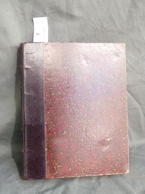 a pink book with a tag on it on a bed