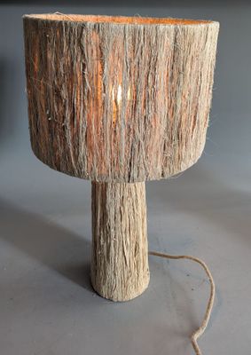 a lamp that is made out of wood on a table