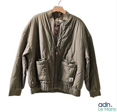 an image of a jacket hanging on a hanger on a white wall
