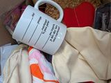 a box full of clothes and a coffee mug in it