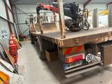 a truck with a crane on the back of it in a warehouse
