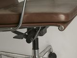 a brown leather office chair with a metal frame