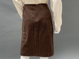 an image of a mannequin wearing a brown skirt and white shirt