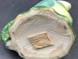 a figurine of a shell with a book on it