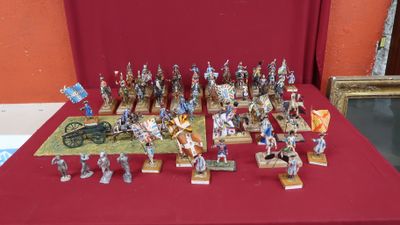 many figurines of soldiers on display on a red table