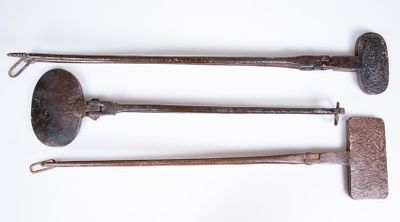 three old tools are sitting on a white surface with a white background
