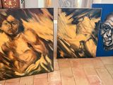 two paintings of a man and a woman on a wooden floor