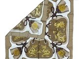 brown and white silk scarf with a gold dragon design on it