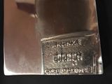 a silver metal object with a label on it