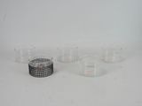 several glasses and a candle holder on a white surface