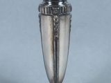 a silver vase that is sitting on a table