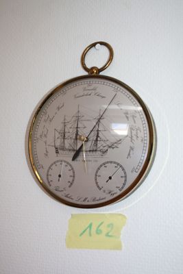 a clock on the wall with a sticker on it