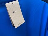 a close up of a blue jacket with a tag on it