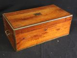 an old wooden box sitting on a black cloth covered table