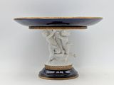 an image of a white and blue vase with a statue on it