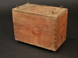 an old wooden box sitting on top of a black surface