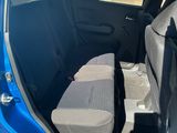 the back of a blue car with the door open and the seats down