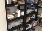 a room with a lot of dishes and containers on the shelves