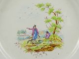 a plate with a picture of a man and a dog on it