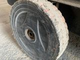 a wheel that is sitting on the side of a truck