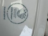a close up of a toilet seat with a sticker on it