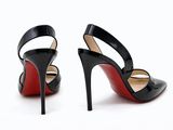 a pair of black and red high heels on a white background