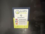 a sign that says sushi foods on the side of a refrigerator