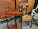 two chairs and a table with a coat rack on it