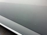 a close up of a car door with scratches on it