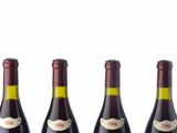 three bottles of wine are lined up in a row on a table