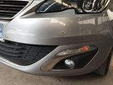 the front end of a silver car with a license plate on it ' s bumper
