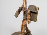 bronze figurine of a man with a hat and a suitcase