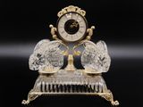 a crystal clock on a stand on a black background