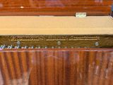 a wooden box that has some screws in it
