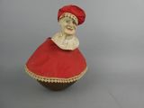 a figurine of a woman wearing a red dress and a red hat